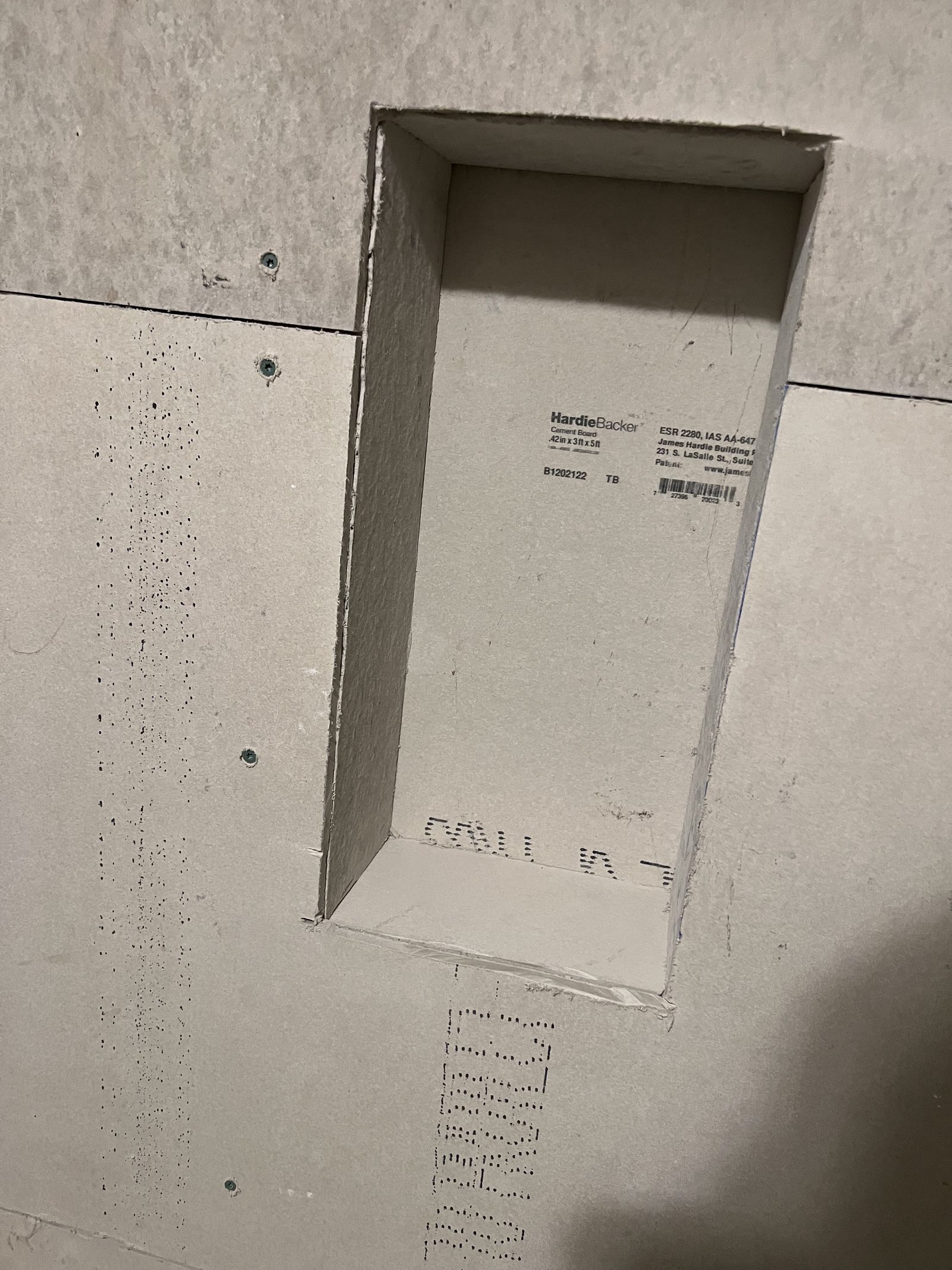 Cement backer board installed around a recessed shower shelf